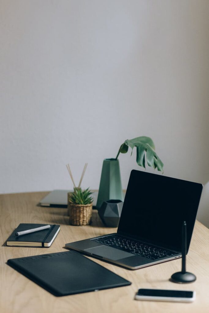 Black Laptop Computer On Brown Wooden Table